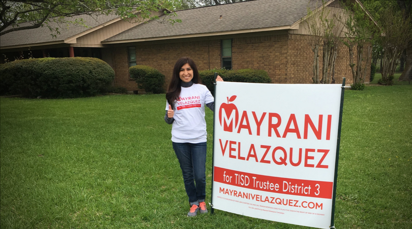 mayrani velazquez holding a campaign poster